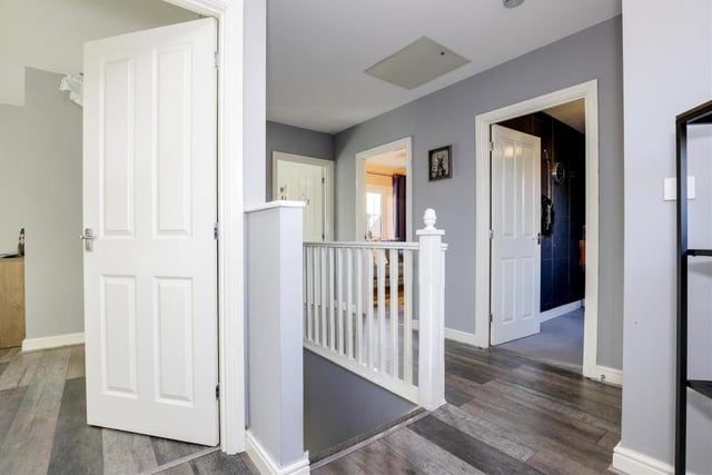 The staircase in the hallway guides you to this first-floor landing. It has laminate flooring, a wall-mounted radiator, a a built-in cupboard, a uPVC double-glazed window to the back of the house and also access to a boarded loft with lighting.
