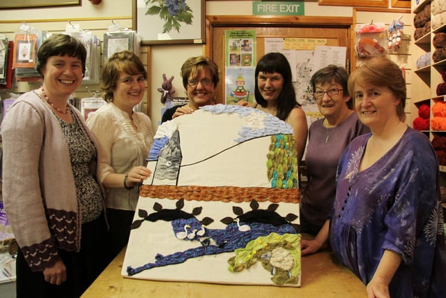 Carol Mycock, Hannah Greatorex, Daphne Cox, Mary Rowley, Brenda Kirk and Kate Greatorex of the Stitched Up knitting group pictured with ther knitted well dressing design which depicts traditional scenes from Bakewell and the Derbyshire countryside in 2011
