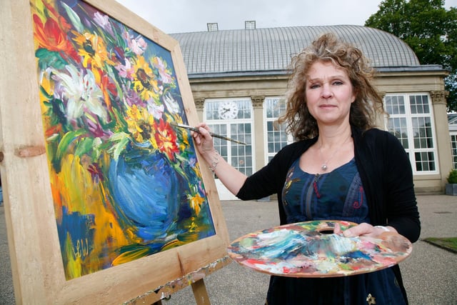 Lynne Wilkinson adding finishing touches to one of her paintings at the Botanical Gardens ahead of the 2009 'Art in the Gardens' event.