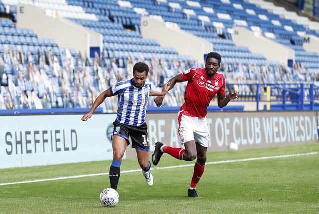 Sheffield Wednesday's Jacob Murphy battles for the ball with  Nottingham Forest's Sammy Ameobi right in front of the assembled cut-outs.
