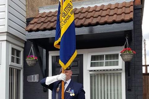 Andrew Barker of Roseberry Road proudly bearing the Royal British Legion standard on VE Day.