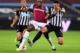 West Ham United's Michail Antonio battles for the ball with Newcastle United's Isaac Hayden (left) and Jamaal Lascelles (right) - Michael Regan/PA