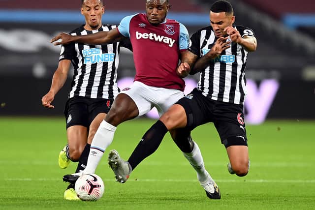 West Ham United's Michail Antonio battles for the ball with Newcastle United's Isaac Hayden (left) and Jamaal Lascelles (right) - Michael Regan/PA