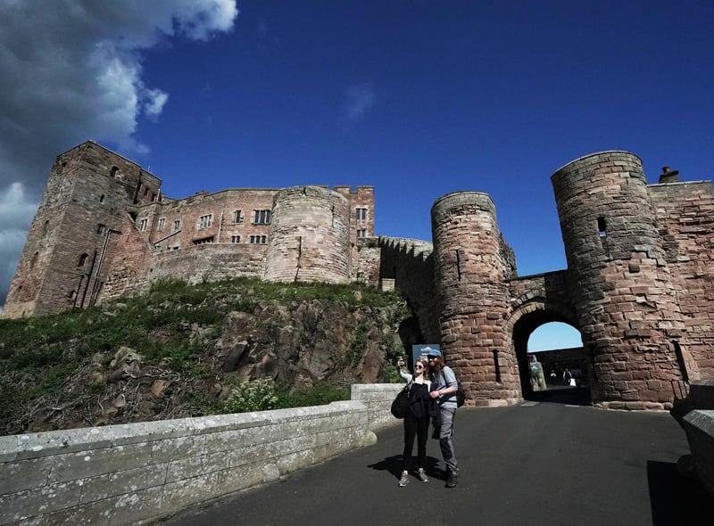 Visitors to Bamburgh Castle take a selfie.