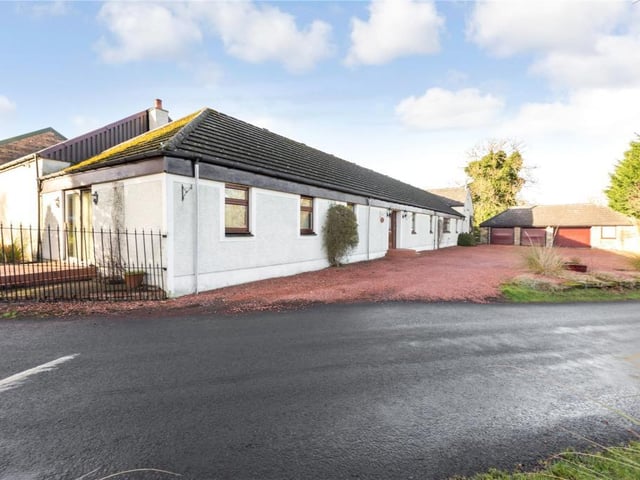 Front entrance with triple garage.