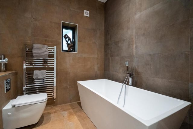 One of the modern bathrooms. The five bedroom home features three ensuites and a family bathroom. 
Image by Rightmove.