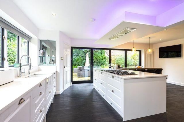 The house boasts an open plan kitchen diner with a central island, and a family area with access out to the gardens