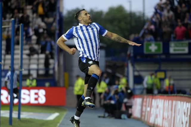 Lee Gregory celebrates in front of the Kop having opened his account for Sheffield Wednesday.