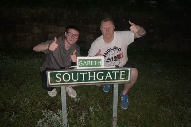 Chris Woolhouse and his stepson Jake Tindale with the amended 'Gareth Southgate' road sign in Eckington