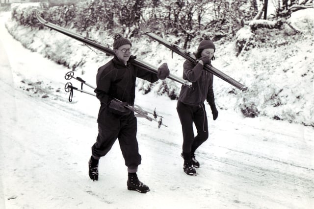 Well equipped to take advantage of a season snow fall, this couple complete with ski-ing equipment make their way up the hill at Mayfields, Fulwood
December 27,  1964