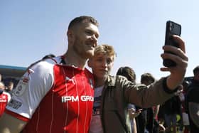 Rotherham United's Michael Smith (left) poses for a photo with a fan after the final whistle of the Sky Bet League One match at the MEMS Priestfield Stadium, Gillingham. Picture date: Saturday April 30, 2022. PA Photo.