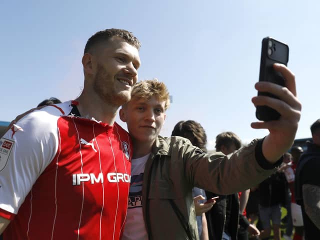 Rotherham United's Michael Smith (left) poses for a photo with a fan after the final whistle of the Sky Bet League One match at the MEMS Priestfield Stadium, Gillingham. Picture date: Saturday April 30, 2022. PA Photo.