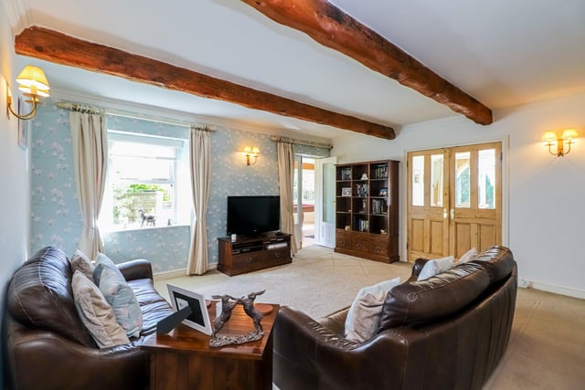 This snug family room provides a cosy space to relax and features a beamed ceiling, a window to the rear and double doors which lead into the adjoining games room.