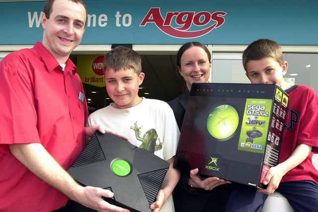 Argos store sales manager Ian Saxton presented Tom Davies, aged 12, with his prize XBOX, watched by his brother Andrew Davies, aged nine, back in 2003