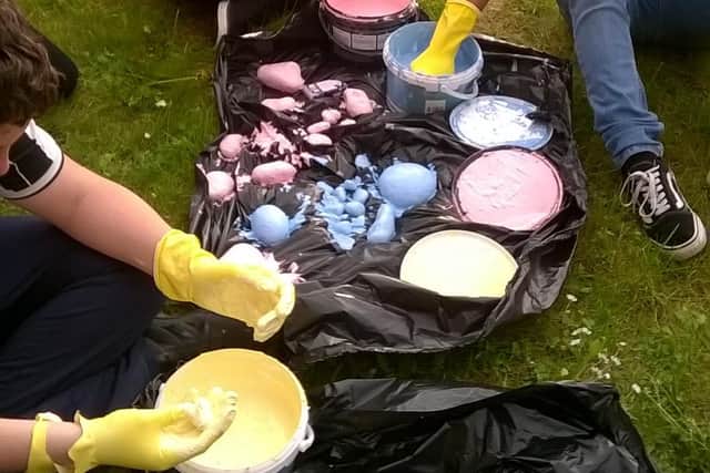 Young people during an activity with paint run by Sheffield Futures