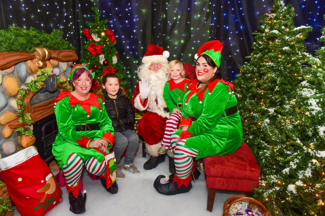 Santa and elves with Jessie (8) and Lacey (4) Robinson in Santa's grotto at Middleton Grange Shopping Centre.