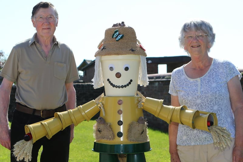 Keith and Sandra Dickinson with their scarecrow creation.