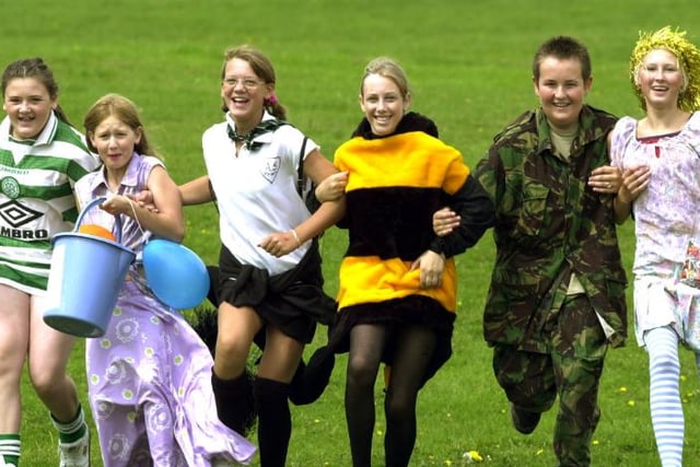 Children running down Cusworth Hall's large hill in 2002.