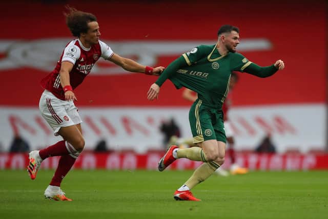 Referee Lee Mason refused to award a foul and send David Luiz off despite this 'challenge' on Oliver Burke at the start of Sheffield United's game against Arsenal: Simon Bellis/Sportimage