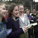 Cathedral choir members sing outside Sheffield Cathedral.