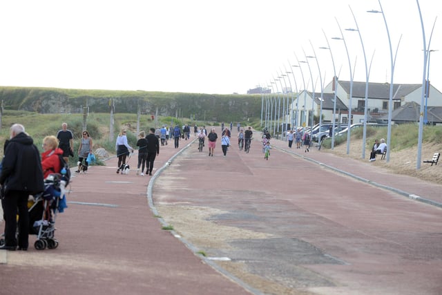 Crowds enjoying a walk along Sandhaven Beach in South Shields.