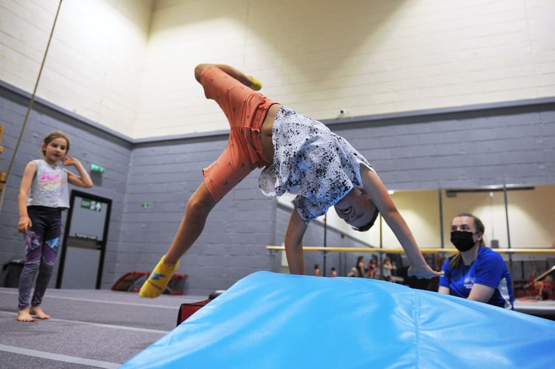 Children enjoy some tumbling fun under the watchful gaze of gymnastic experts