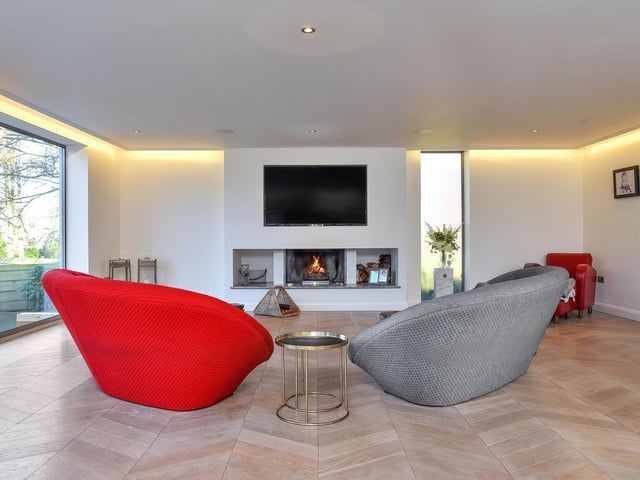 A stunning open-plan bespoke kitchen with living and dining areas that benefit from bi-folding doors onto a large terrace.