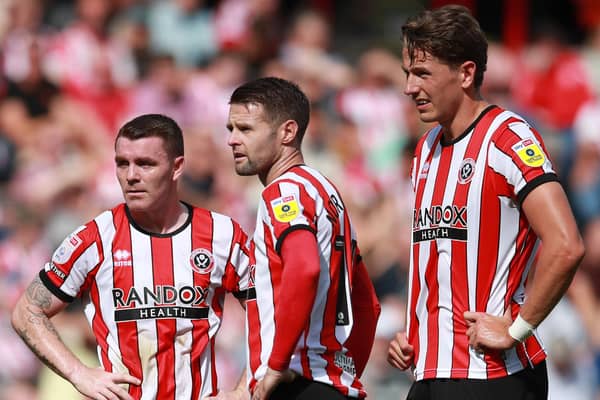 John Fleck, Ollie Norwood and Sander Berge of Sheffield United stand over a free-kick: Simon Bellis / Sportimage