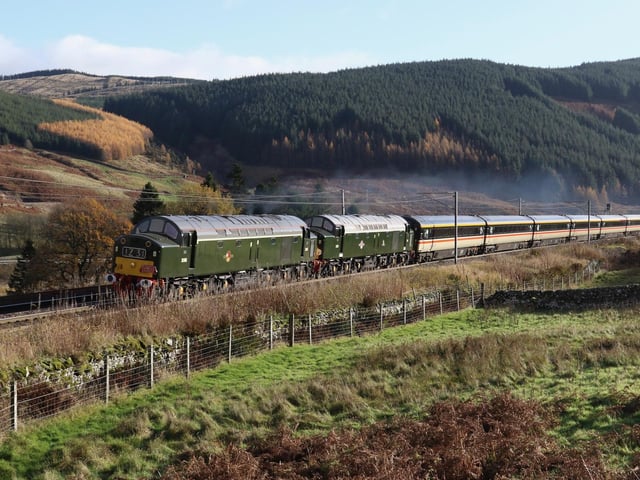 On a beautiful late autumn day, the ‘Double Scotch’ charter gets to grips with the gradient at Beattock en route to Edinburgh from Crewe.The two diesels heading the train are now sixty years old ,having survived in preservation from the early 60s when they replaced steam before the completion of electrification on the West Coast Main Line.