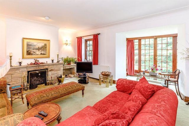 The spacious sitting room is light and airy, and boasts patio doors which provide access to the extensive grounds.