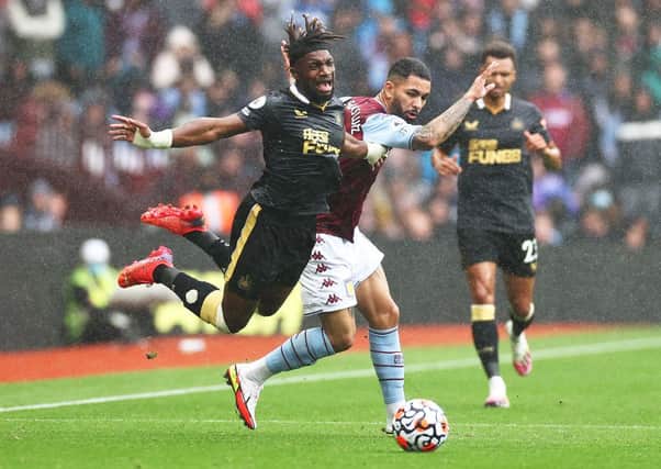 Allan Saint-Maximin of Newcastle United is challenged by Douglas Luiz of Aston Villa during the Premier League match between Aston Villa and Newcastle United at Villa Park on August 21, 2021 in Birmingham, England. (Photo by Ryan Pierse/Getty Images)