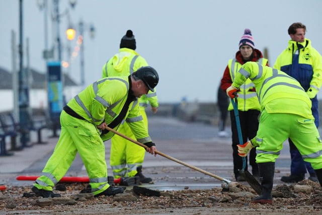 Colas contractors, working on behalf of the city council, clear up on Clarence Esplanade, Southsea, after Storm Barra. Picture: Chris Moorhouse   (jpns 071221-14)