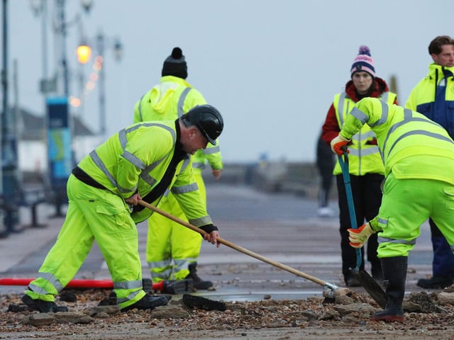 Colas contractors, working on behalf of the city council, clear up on Clarence Esplanade, Southsea, after Storm Barra. Picture: Chris Moorhouse   (jpns 071221-14)