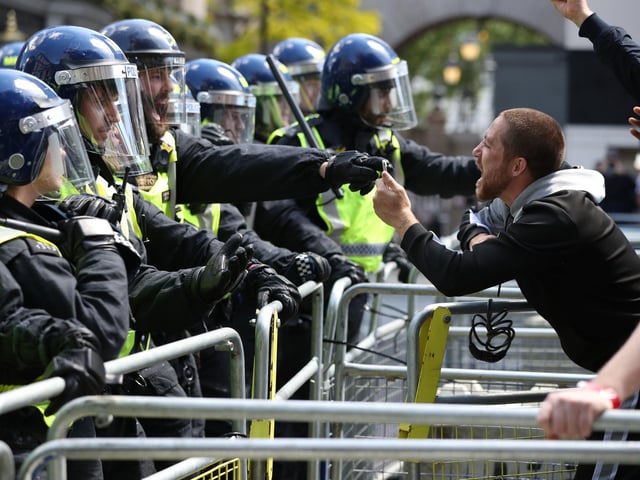 Police are confronted by protesters in Whitehall near Parliament Square. Picture: Jonathan Brady/PA Wire