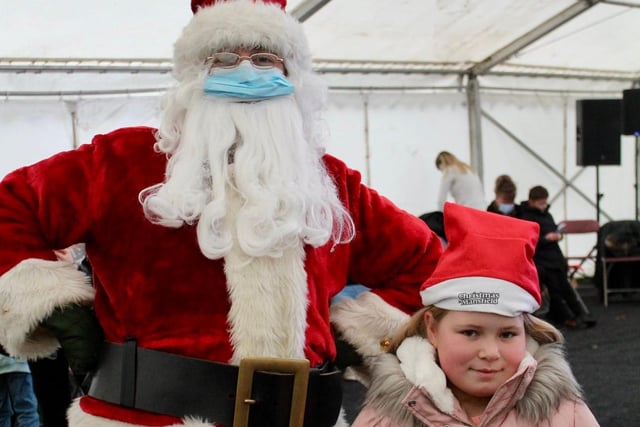 It's that man again! Santa doing his best to cheer up this youngster at the festival.