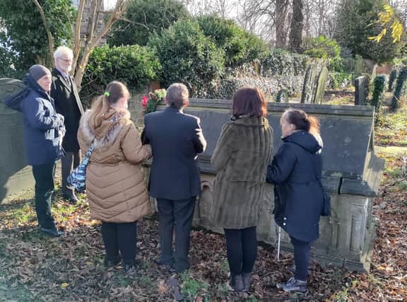 Photo of everyone standing around Eliza’s grave