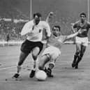 Jimmy Greaves (L) battles with French footballer Jacky Simon, during the match between France and England of the football World Cup, at the Wembley stadium. - The former England striker Jimmy Greaves has died aged 81, his former club Tottenham Hotspur announced on Sunday, September 19, 2021. (Photo by STRINGER / AFP) (Photo by STRINGER/AFP via Getty Images)