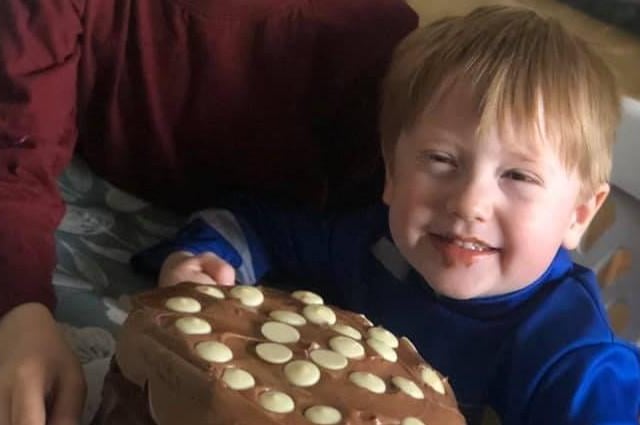 Jack, three, with the cake he and brother Harry, seven, pictured above, baked after Harry researched the recipe on the internet.