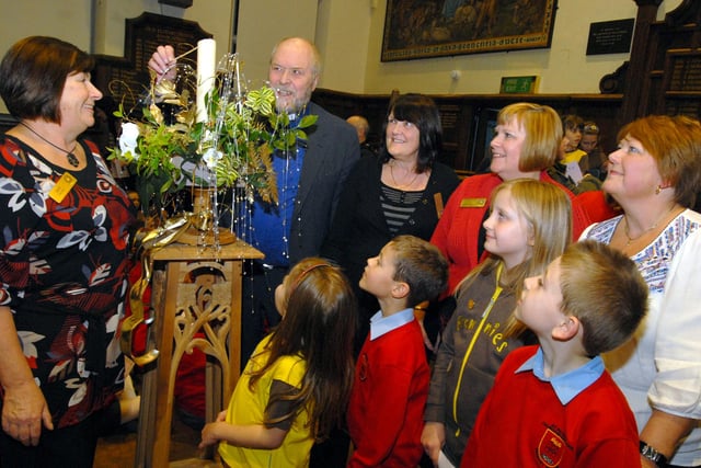 In 2009 Rev Paul Bentley, Chaplain to the John Eastwood Hospice, pictured at the switch on for the S.H.I.N.E. Tree of Lights at Queen Elizabeths School. Also pictured from the left are S.H.I.N.E. members Sue Welton, Elizabeth Woods, Hilary Canham and Sandra Wilkins. Children pictured are; Ebony Peters and Marie Kirkb from St Augustines Brownies and Oliver Bloodworth and Cameron Rocky-Clewlo from St Peters School Choir