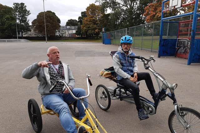 Vincent O'Neill, left, who works for support service Home Instead, and his client George Morton enjoying a Sheffield Cycling 4 All session at Hillsborough Park in 2022 on the MUGA area that is set to be turned into a partly paid-for activity hub. Picture: Julia Armstrong, LDRS