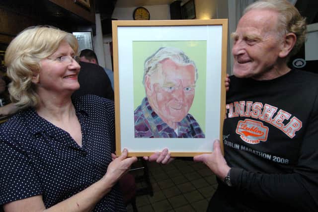 Musician John Dowling pictured at the Dog and Partridge pub, Sheffield with a painting of him by artist Keith South, pictured with landlady Ann Flynn, in November 2008