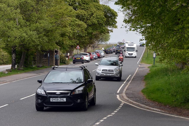 Cars parked near longshaw estate as the road get busy.