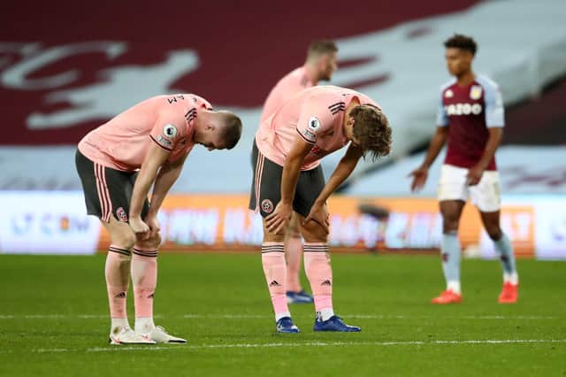 John Lundstram and Sander Berge of Sheffield United react after the Premier League match against Aston Villa (Photo by Tim Goode - Pool/Getty Images)