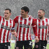 Billy Sharp celebrates with Morgan Gibbs-White and Conor Hourihane after scoring Sheffield United's second goal against Bristol City: Alistair Langham / Sportimage