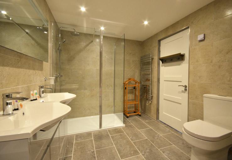 The ensuite includes both a walk-in shower and a luxuriously deep bath.