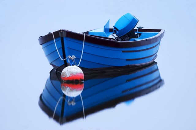 Dead Calm. A reflection of a blue boat looking like its been placed on a mirror at Emsworth Mill Pond back in 2011.