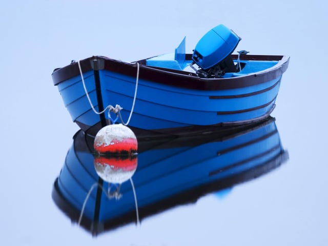 Dead Calm. A reflection of a blue boat looking like its been placed on a mirror at Emsworth Mill Pond back in 2011.