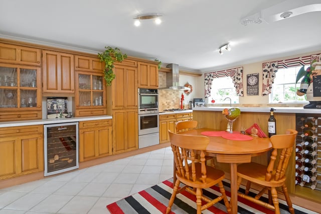 The kitchen has a breakfast area and tiled flooring as well as a range of Neff appliances that come with the house.