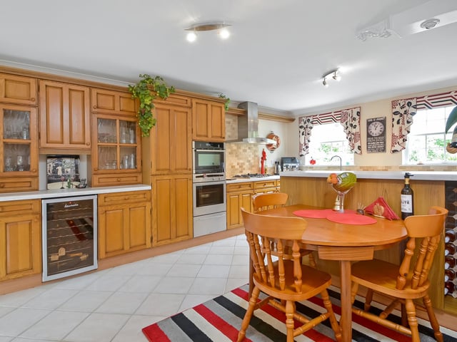 The kitchen has a breakfast area and tiled flooring as well as a range of Neff appliances that come with the house.