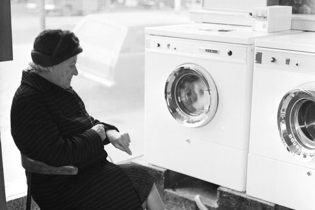 Time moves slow for this woman waiting for her washing to finish spinning.